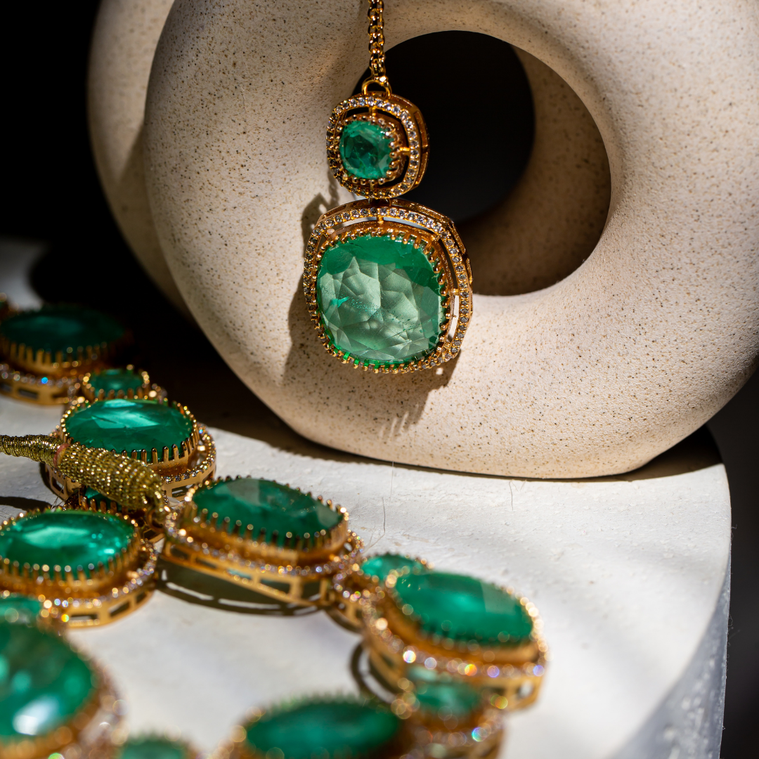 The Vera Maala Set with double-layer green necklace, earrings, and maang tikka in gold base

