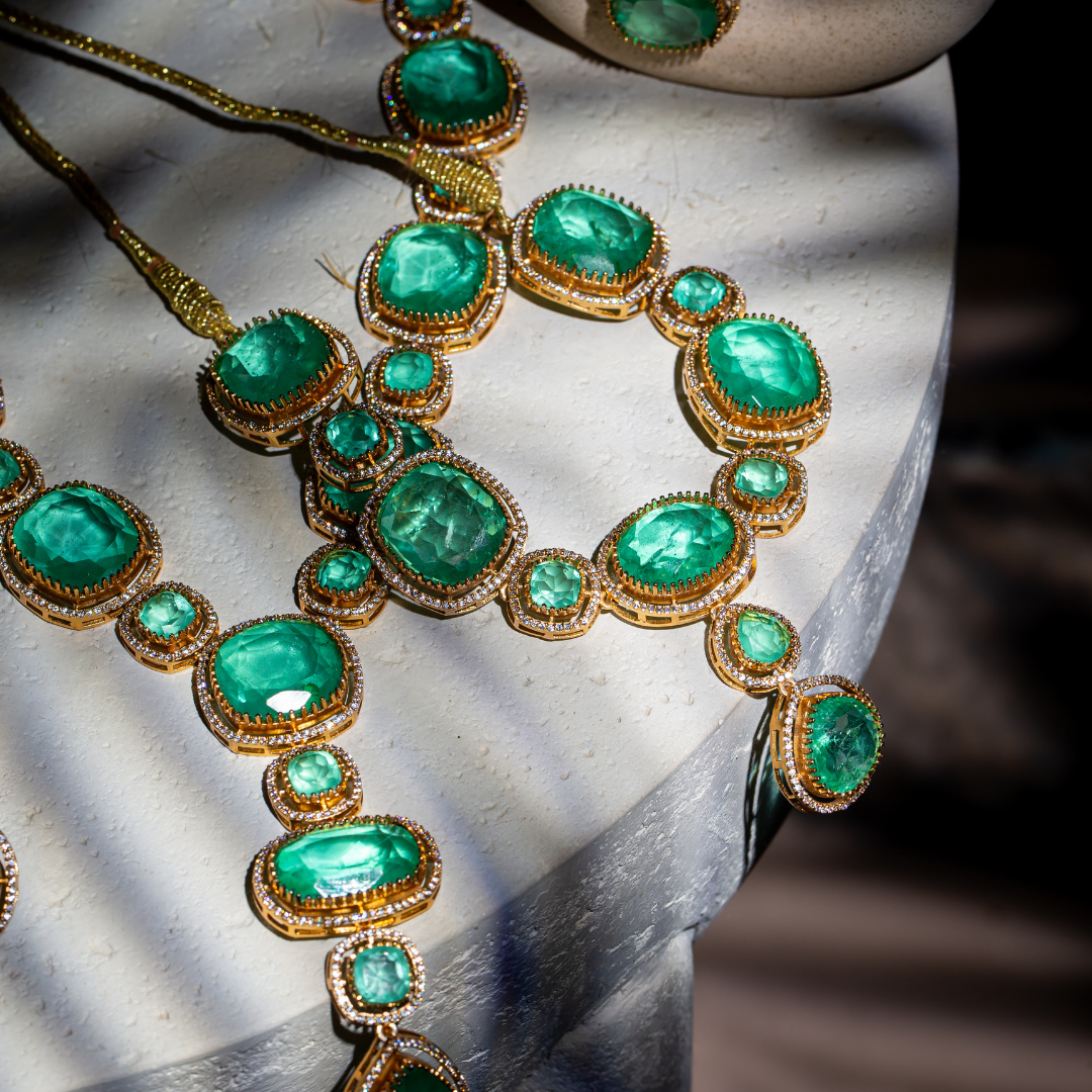 The Vera Maala Set with double-layer green necklace, earrings, and maang tikka in gold base

