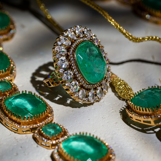 the vera ring - Gold plated oval green stone ring with crystal border.







