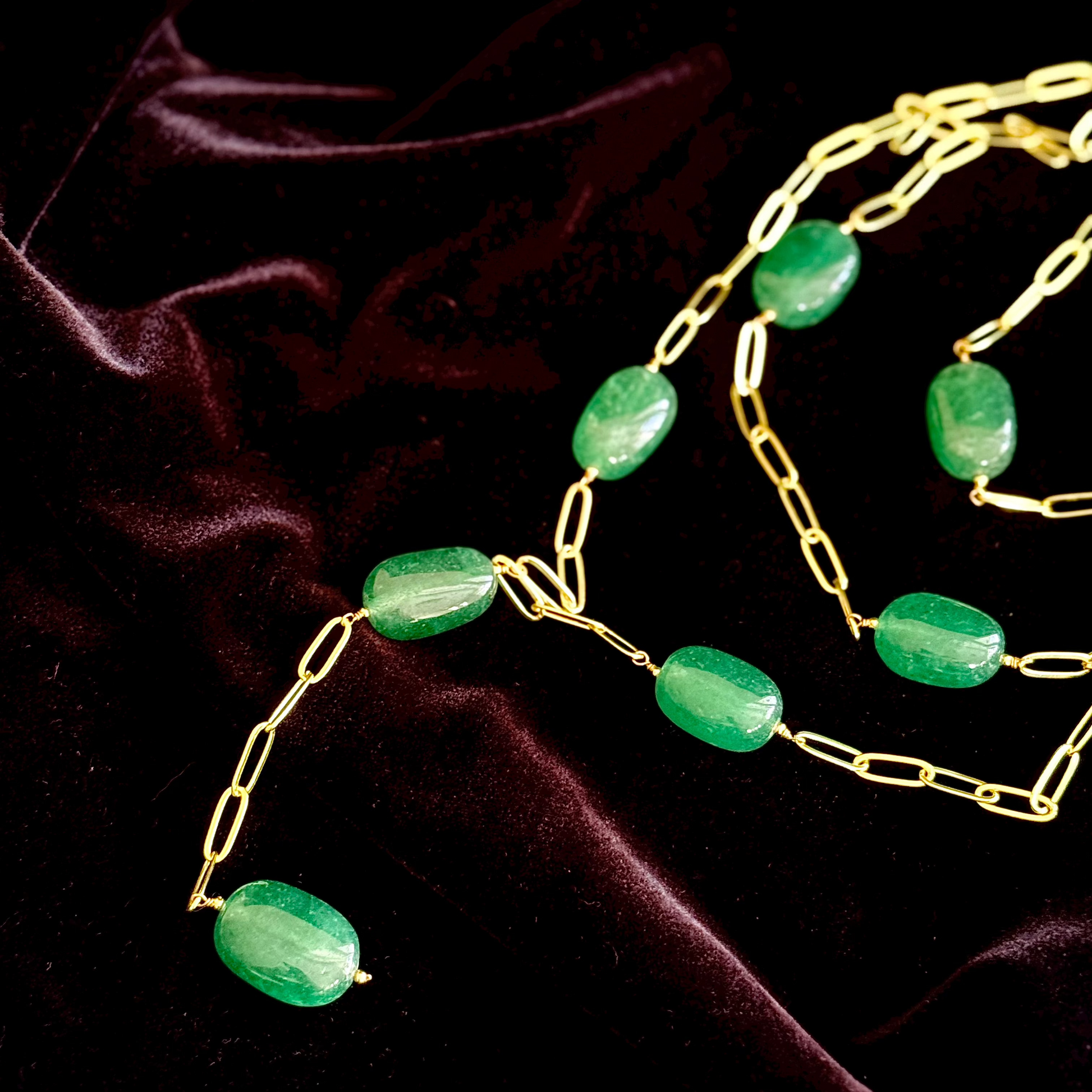 Trilogy Necklace with emerald-toned oval stones and gold-plated layered paperclip chains

